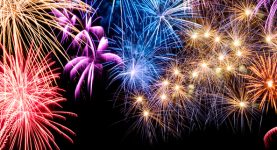 Gorgeous multi-colored fireworks display on black background with copyspace
